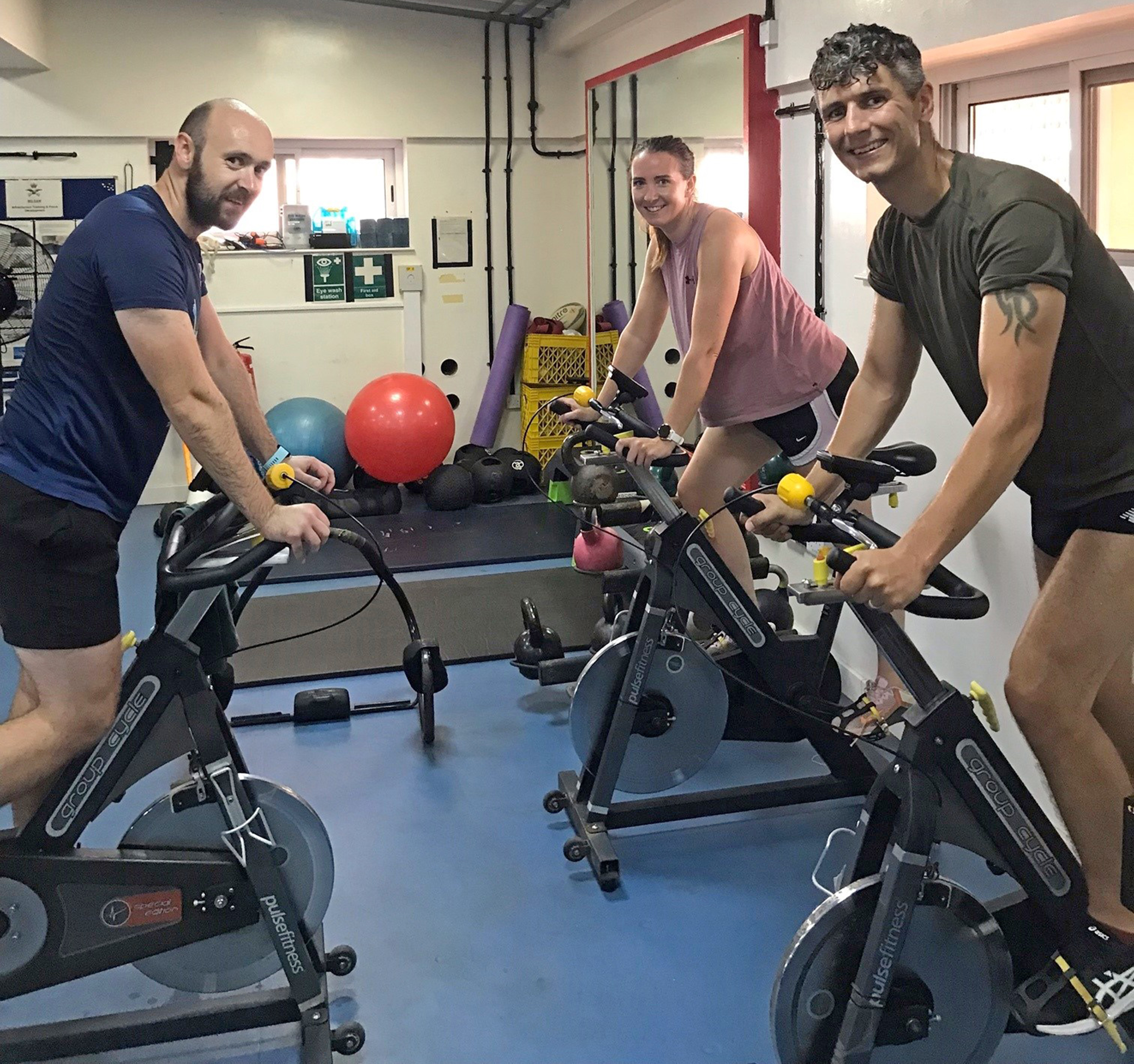 Image shows aviators in the gym on stationary bikes.